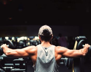 Midsection of man with arms raised