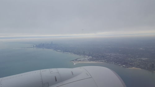 Aerial view of cityscape and sea against sky