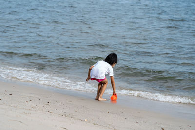 Rear view of girl on beach