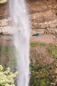 Man slacklines beautiful, blue spring in upstate new york, catskills