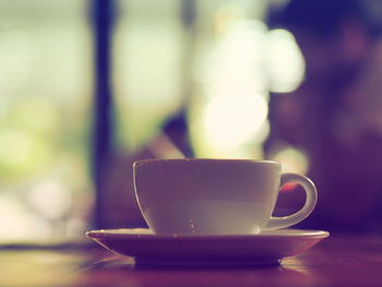 Coffee cup served on wooden table in cafe