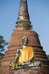 Low angle view of buddha statue at wat mahathat