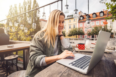 Young woman using laptop at table