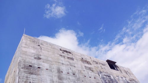 Low angle view of old building against blue sky