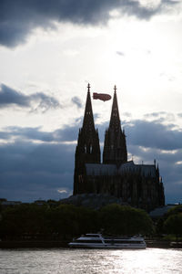 Temple by building against sky