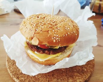 Close-up of cheeseburger burger on table paper waxed paper 