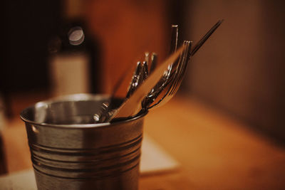 Close-up of paintbrushes in bowl on table