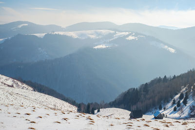 Sun over the winter mountains with snow, cindrel mountains, paltinis, romania