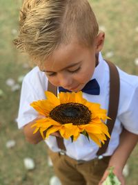 Close-up of boy holding white flower