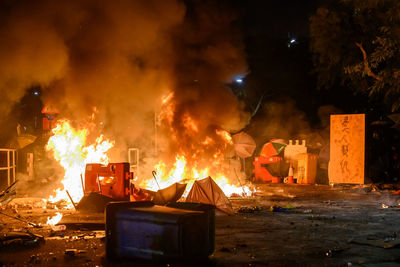 Panoramic view of fire against buildings at night