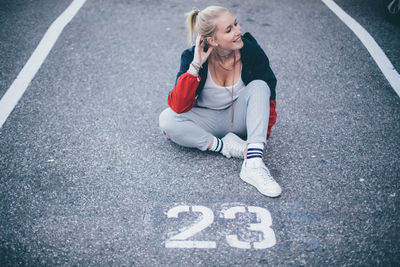 High angle view of woman sitting on road