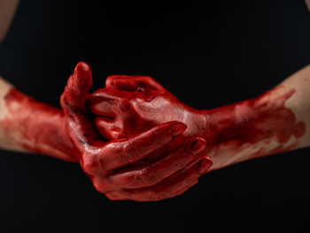 Close-up of human hand against black background