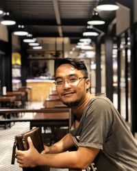 Portrait of young man sitting at home