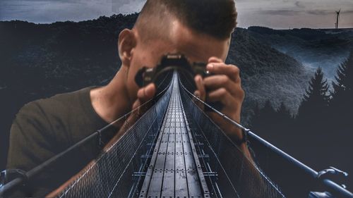 Portrait of young man on railing