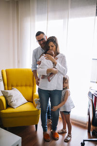 Side view of young woman sitting on bed
