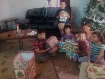 Full length of children sitting in kitchen