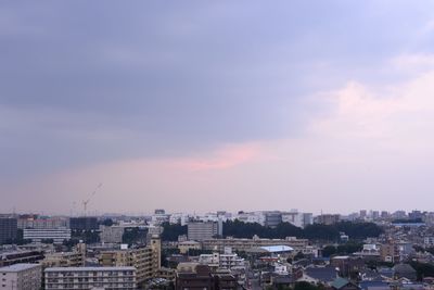 Cityscape against cloudy sky