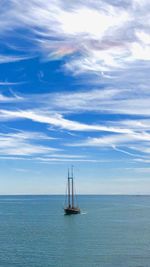 Sailboat sailing in sea against sky