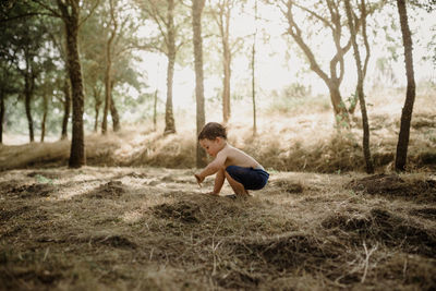 Child playing outdoors with soil