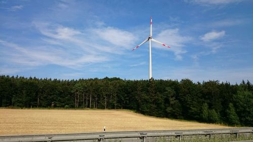 Scenic view of field against cloudy sky