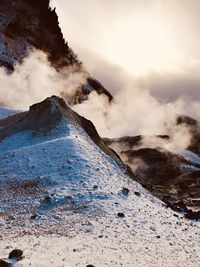 Smoke emitting from volcanic mountain against sky