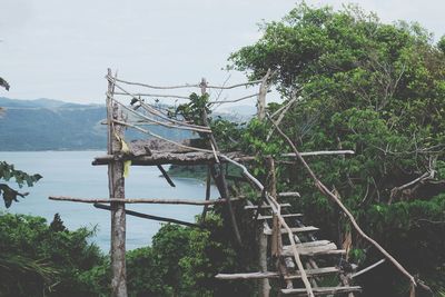 Built structure by trees against sky