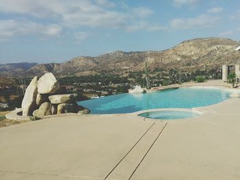 Scenic view of sea and mountains against sky