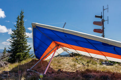 Low angle view of traditional windmill against clear blue sky