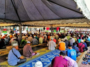 Group of people at market stall in city