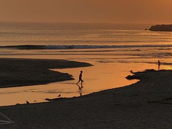 Scenic view of beach against sky during sunset