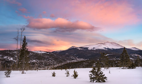 Scenic view of snowcapped mountains against sky during sunset