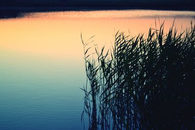 Scenic view of lake against sky at sunset