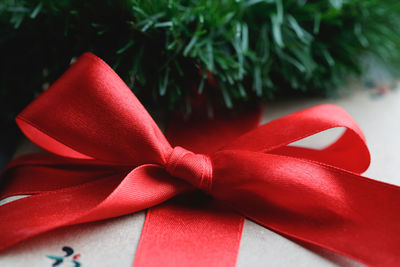 Close-up of christmas present with red ribbon