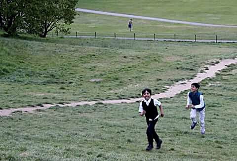 grass, leisure activity, lifestyles, childhood, full length, boys, casual clothing, elementary age, girls, focus on foreground, playing, park - man made space, field, green color, person, sport, day, fun