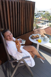 Midsection of woman sitting on table