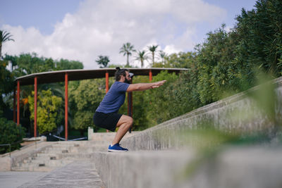 Full length of man jumping in mid-air against sky