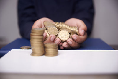 Close-up of hand holding coins