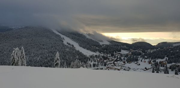 Scenic view of snow covered mountains against sky