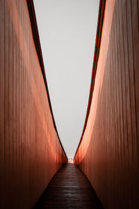 View of narrow alley against clear sky