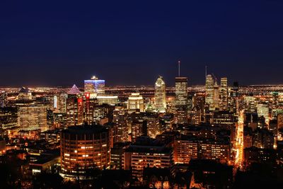 Aerial view of illuminated buildings in city at night