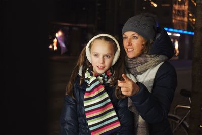 Portrait of mother and daughter in park during winter