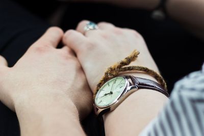 Cropped image of couple holding hands