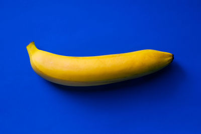 Close-up of yellow fruit against blue background