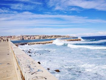 Scenic view of sea against cloudy sky