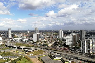 High angle view of street amidst buildings against sky