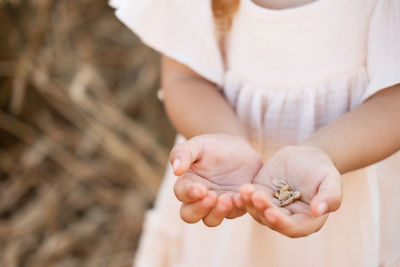 Midsection of woman holding snail