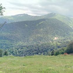 Scenic view of field and mountains against sky