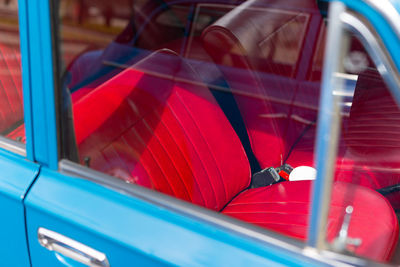 Blue vintage car with red seat