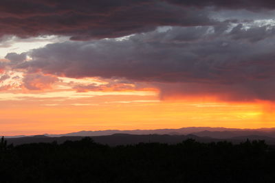 Scenic view of silhouette landscape against romantic sky at sunset