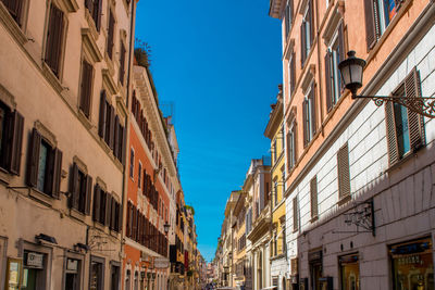 Low angle view of residential buildings against blue sky